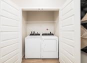 Thumbnail 43 of 58 - a white washer and dryer in a laundry room with white doors