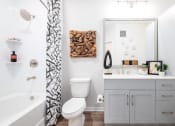 Thumbnail 42 of 58 - a bathroom with a shower curtain and a toilet and a sink