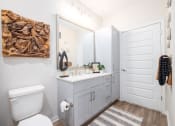 Thumbnail 36 of 58 - a bathroom with a toilet sink and a mirror
