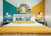 Thumbnail 45 of 58 - a bedroom with a yellow bed and a green wall and a painting on the wall