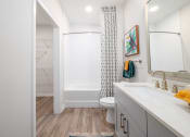 Thumbnail 50 of 58 - a bathroom with a shower and a sink and a toilet