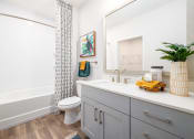 Thumbnail 51 of 58 - a bathroom with a tub and a toilet and a sink