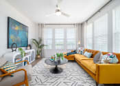 Thumbnail 47 of 58 - a living room with a yellow couch and a ceiling fan