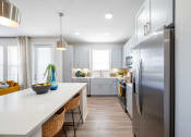 Thumbnail 49 of 58 - a kitchen with stainless steel appliances and a white counter top