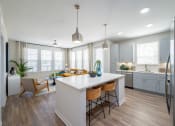 Thumbnail 56 of 58 - an open kitchen and living room with a white counter top