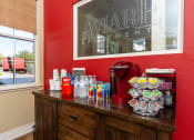 Thumbnail 10 of 44 - a snack counter in a room with a red wall and a window