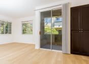 Thumbnail 15 of 44 - a living room with a sliding glass door to a bathroom