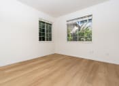 Thumbnail 16 of 44 - a room with white walls and wood floors and a window