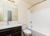 Thumbnail 17 of 44 - a bathroom with a toilet sink and tub and a mirror
