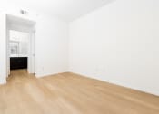 Thumbnail 21 of 44 - an empty room with white walls and wooden floors
