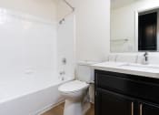 Thumbnail 30 of 44 - a bathroom with a toilet and a tub and a sink