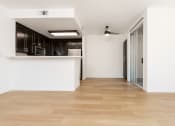 Thumbnail 31 of 44 - an empty living room with white walls and wood floors