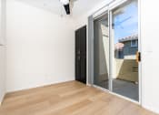 Thumbnail 33 of 44 - an empty living room with a sliding glass door to a patio