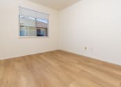 Thumbnail 36 of 44 - an empty room with wood floors and a window