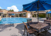 Thumbnail 5 of 44 - our resort style swimming pool is surrounded by patio furniture and umbrellas