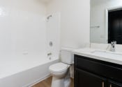 Thumbnail 40 of 44 - a bathroom with a toilet and a tub and a sink