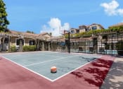 Thumbnail 6 of 44 - a basketball court in a fenced in backyard with a ball on it
