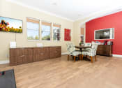 Thumbnail 7 of 44 - a dining room with red walls and a table and chairs