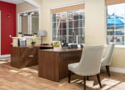 Thumbnail 9 of 44 - an office with a desk and chairs and a window