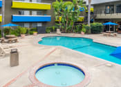 Thumbnail 1 of 13 - a large swimming pool with a building in the background