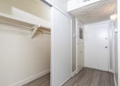 Thumbnail 5 of 38 - A white closet with a sliding door and a white door.