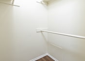 Thumbnail 16 of 17 - A white wall with a corner and a white baseboard.