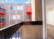 Thumbnail 17 of 17 - A balcony with a black railing and a red object on the wall.