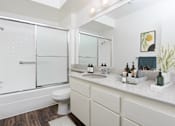 Thumbnail 13 of 17 - a bathroom with a shower and a sink and a toilet