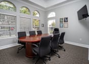 Thumbnail 8 of 36 - A conference room with a large table and chairs.