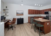 Thumbnail 14 of 36 - A kitchen with a brown counter and a fridge.