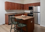 Thumbnail 15 of 36 - A kitchen with a table and two chairs.