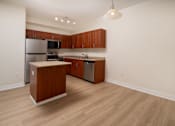 Thumbnail 23 of 36 - A kitchen with wooden cabinets and a wooden island.