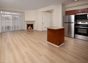 Thumbnail 26 of 36 - A kitchen with a wooden island and stainless steel appliances.