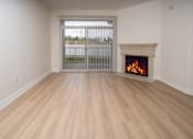 Thumbnail 24 of 36 - A room with a fireplace and a window with bars.