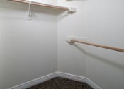 Thumbnail 28 of 36 - A white wall with a brown trim and a white shelf.