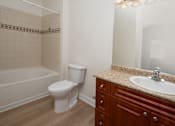 Thumbnail 29 of 36 - A white toilet sits next to a sink in a bathroom.