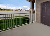 Thumbnail 32 of 36 - A balcony with a purple door and a metal railing.