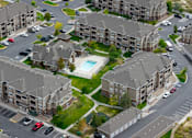 Thumbnail 33 of 36 - An aerial view of apartment buildings with cars parked in the driveways.