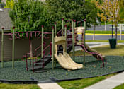 Thumbnail 35 of 36 - A playground with a slide and a climbing frame.