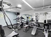 Thumbnail 20 of 20 - a room filled with lots of different types of exercise equipment for resident use at King Arthurs Court, Seattle, 98125