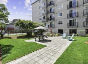 Thumbnail 9 of 20 - Resident community patio with outdoor lounge seating at King Arthurs Court, Washington, 98125