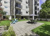 Thumbnail 8 of 20 - Resident patio space with a table and chairs for relaxing at King Arthurs Court, Seattle