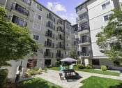 Thumbnail 1 of 20 - Resident Courtyard patio with a table and chairs at King Arthurs Court, Washington