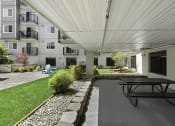 Thumbnail 13 of 20 - a covered patio with a picnic table and chairs at King Arthurs Court, Seattle