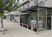 Thumbnail 2 of 22 - View of the property entrance from the side with artsy iron patio wall at Villaggio Apartment Homes, Tacoma, Washington 98402