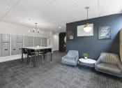 Thumbnail 7 of 22 - Cozy Lobby Area with a table and chairs and convenient mailboxes on the wall at Villaggio Apartment Homes, Tacoma, 98402