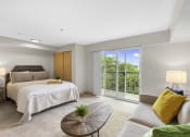 Thumbnail 11 of 22 - Studio Apartment with Cozy bedroom with a bed and a couch at Villaggio Apartment Homes, Tacoma, WA