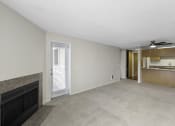 Thumbnail 8 of 19 - a living room with a fireplace and a kitchen in the background at Willows Court Apartment Homes, WA 98125