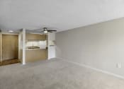 Thumbnail 3 of 19 - an unfurnished living room with a ceiling fan and a kitchen in the background at Willows Court Apartment Homes, Seattle, 98125