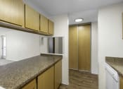 Thumbnail 13 of 19 - a kitchen with granite countertops and wooden cabinets at Willows Court Apartment Homes, Washington